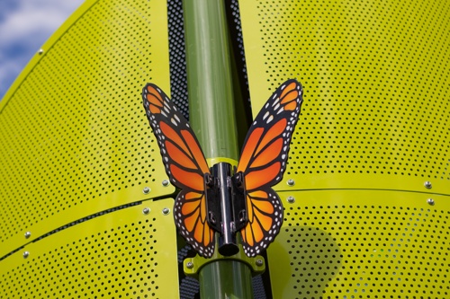 Digifuse butterfly perched on playground post