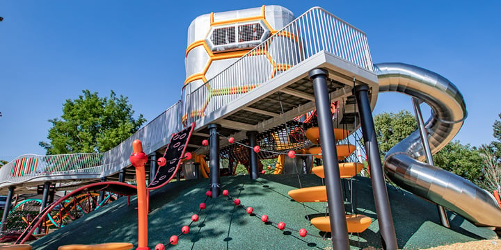 A view from below the ADA wheelchair ramp of the main playground structure at Paco Sanchez playground. 