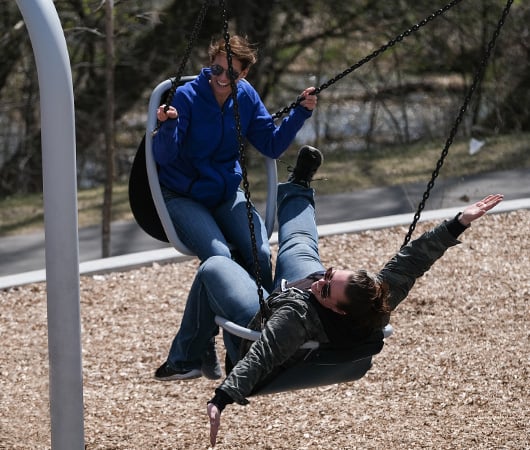 Close in photo of female employee coming down a curved slide