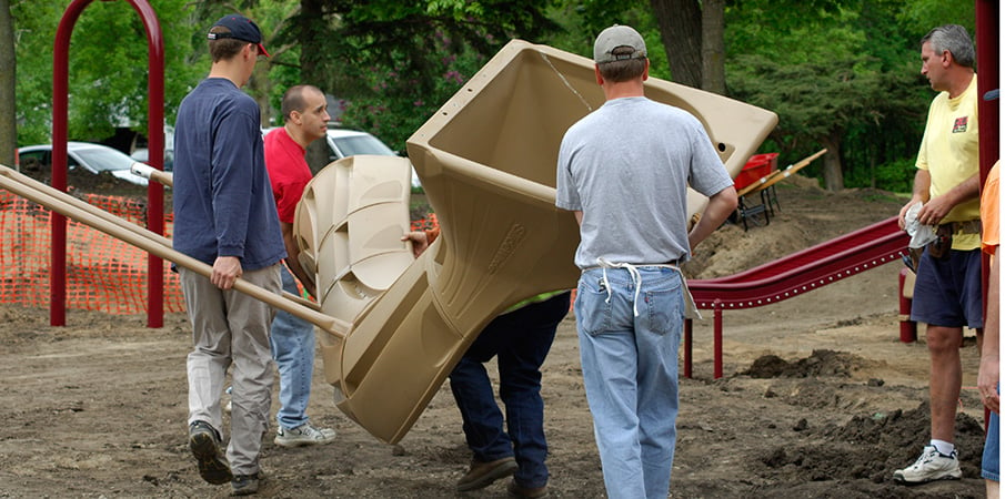 Volunteers carrying assembled Rushwinder slide.