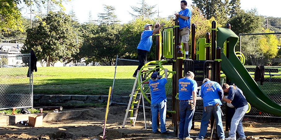 Volunteers building a PlayBooster playground.