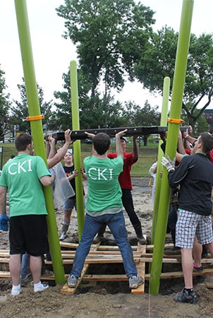 Volunteers building a playground decking system.