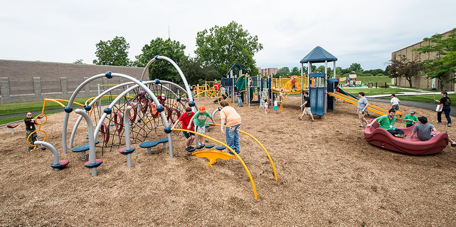 Children play all over a Evos and PlayBooster play systems.