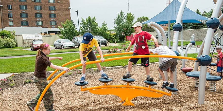 Young boy playing on a Evos PodStomper Bridge.