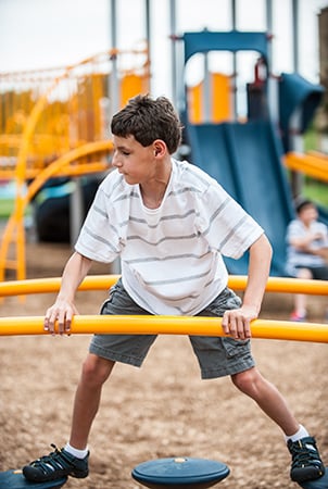 Young boy playing on a Evos PodStomper Bridge.