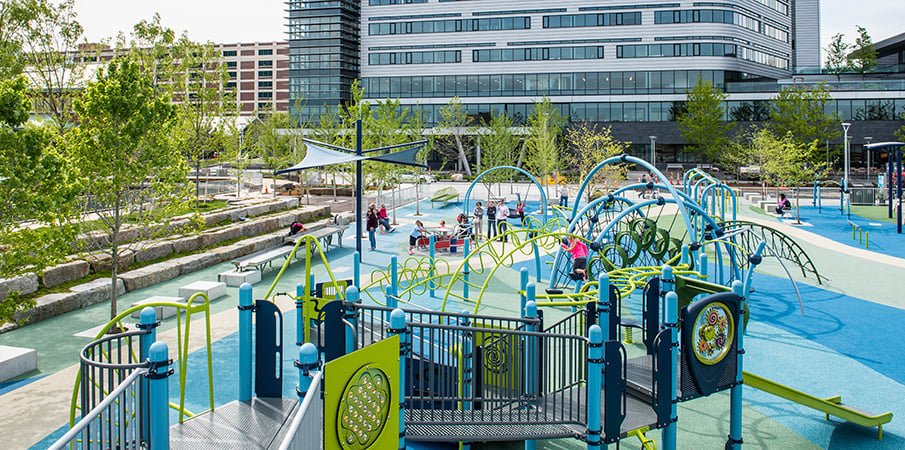 A PlayBooster and Evos playground structures on top of PebbleFlex playground safety surfacing.